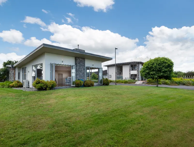 Main resort facilities beside the lawn at Karapiro Villas Resort